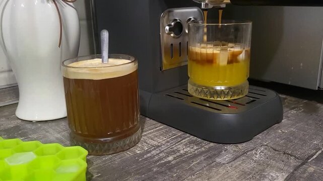Freshly prepared bumble coffee with ice and orange juice on a tray. refreshing summer beverage, cafe service, cold drink.