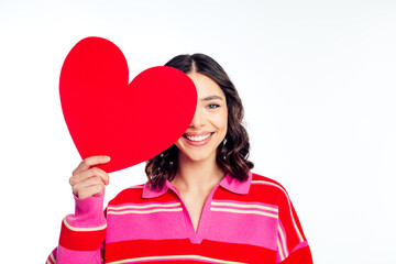 Naklejka premium Smiling young woman holding a large red heart cutout for Valentine and love concept portrait