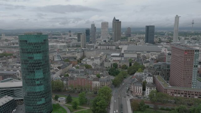Aerial view of the Frankfurt skyline featuring modern skyscrapers and urban architecture under a cloudy sky in Frankfurt am Main, Hessen, Germany.