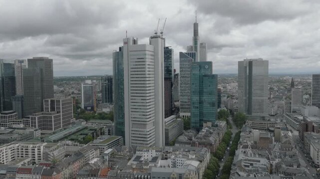 Aerial view of the modern skyscrapers and historic buildings of the Frankfurt skyline under a cloudy sky in Frankfurt am Main, Hessen, Germany.