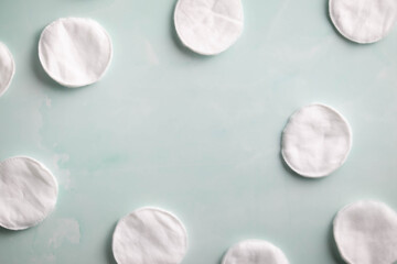 Soft, white, cotton rounds frame a light blue background.  Skin care, beauty routine concept © Deborah
