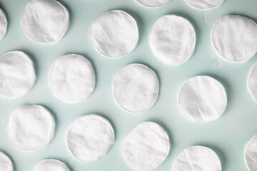 Soft, white, cotton rounds on a light blue background.  Skin care, beauty routine concept © Deborah