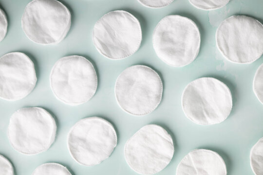 Soft, white, cotton rounds on a light blue background.  Skin care, beauty routine concept
