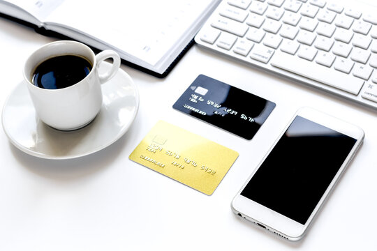 credit card, keyboard, smartphone and coffee cup on white background