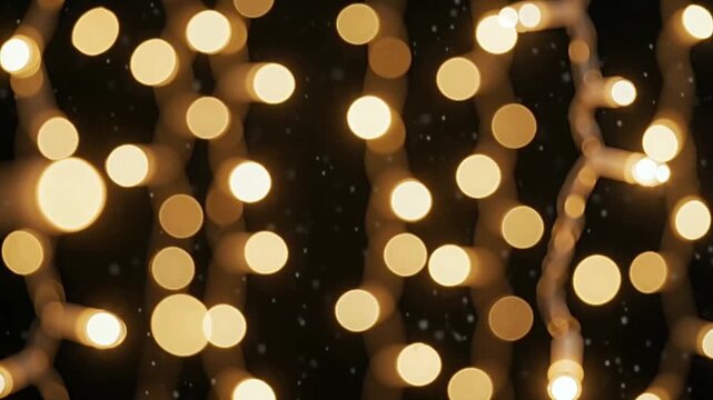 Golden christmas fairy lights twinkling softly on dark background with gentle glow