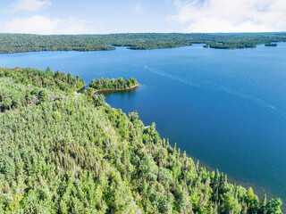 Aerial view of a commercial waterfront property with lush forest and large lake exterior architecture style commercial waterfront property architecture exterior building investment landscape