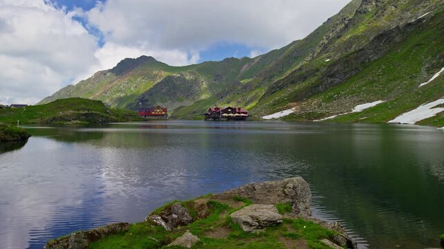Green Balea Lake Beneath Snowy Fagaras Slopes
