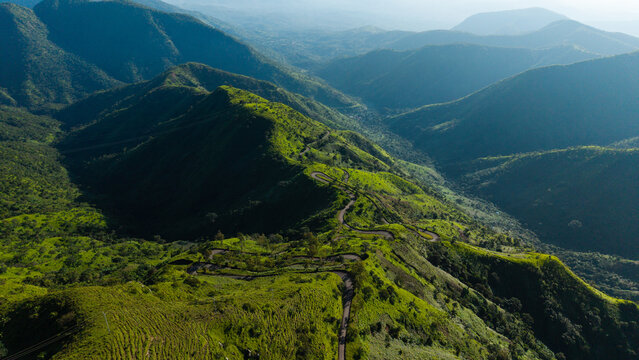 Aerial view of the winding road leading through the lush green mountains of Obudu Mountain Resort in Obudu, Cross River, Nigeria.