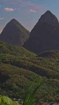 Vertical panning shot of the Pitons mountain peaks in St Lucia at sunrise