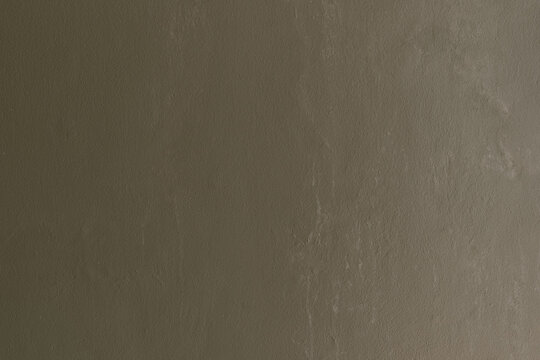 Olive green wall background with clean smooth painted concrete surface texture.