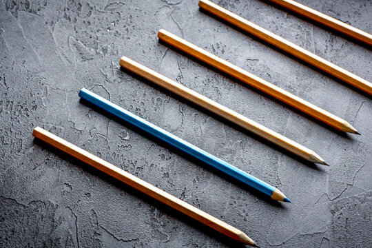 concept selection options with pencils on dark background top view