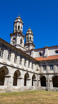 Towers of the Monastery of Sobrado through the stone cloister