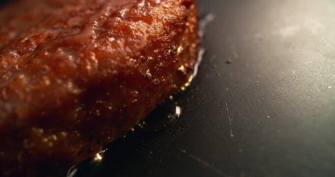 Hot juicy hamburger sizzling on a griddle with aromatic smoke rising around it, capturing a mouthwatering cinematic close-up of freshness, heat, texture and irresistible comfort food.