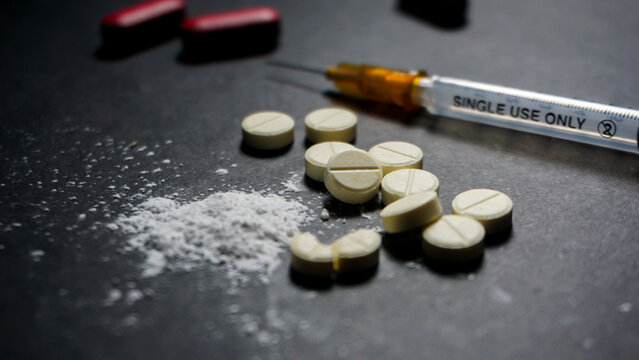Some illegal drugs and one ml size of disposable syringe. 