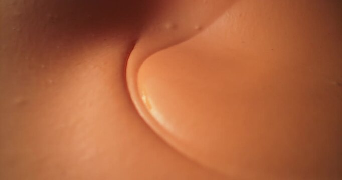 Macro close-up of creamy sauce twisting into flowing waves and soft vortices, highlighting its glossy consistency, rich texture and irresistibly indulgent gourmet appeal.