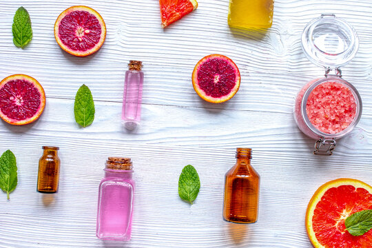 organic cosmetic with citrus on wooden background top view