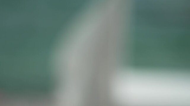Blurred abstract background, soft light ethereal green white, calm peaceful mood. Vertical video.