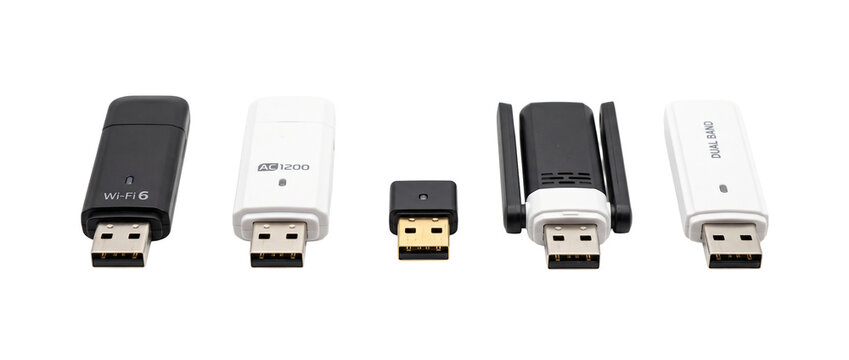 USB Wi-Fi adapter wireless dongles lined up showing modern high-speed network hardware receiver options for fast internet connectivity and wireless connection isolated on a black background.