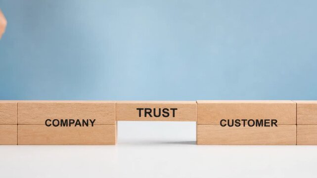 Business trust concept with wooden blocks bridging company and customer on blue background