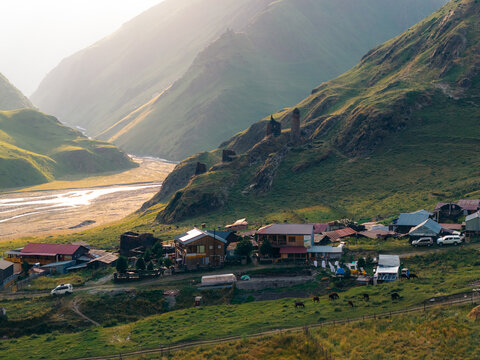Aerial view of Girevi Tusheti National Park featuring traditional stone towers and houses nestled in a lush green valley with a winding river in Girevi, Kakheti, Georgia.