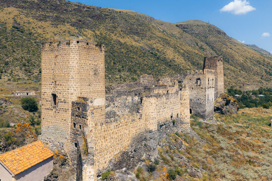 Aerial view of Khertvisi Fortress with its ancient stone towers and defensive walls set against a rugged mountainous landscape in Aspindza Municipality, Samtskhe-Javakheti, Georgia.