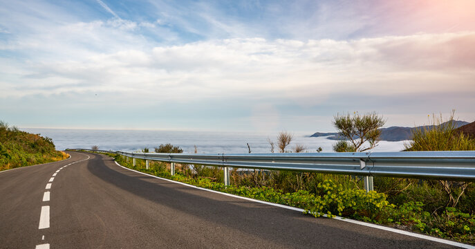 Mediterranean sea coast road into mountains horizon in summer with beautiful bright sun rays