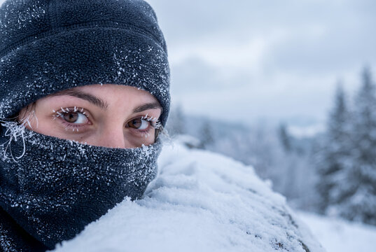 Woman in snow with frozen face winter extreme cold weather