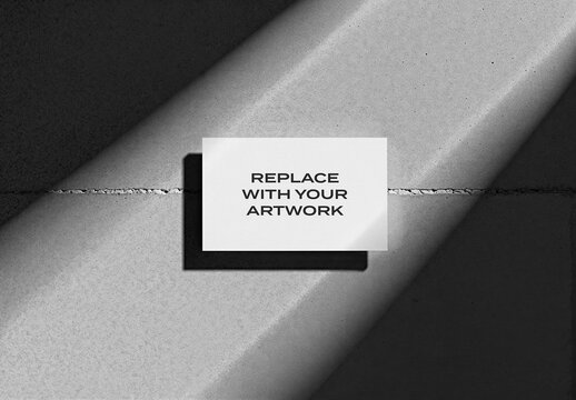 Vertical business card mockup displayed on a textured concrete surface with diagonal lighting, realistic stationery branding presentation, template for graphic design and print