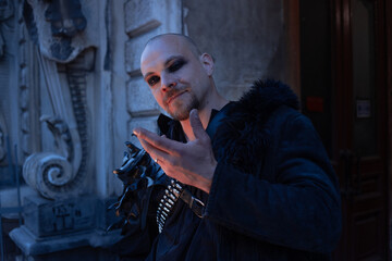 Fototapeta premium Dark magician making a hand gesture, spell and magic concept in gothic male style.