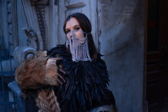 Designer leather cape with feather cut and a chain face mask, handmade fashion craft