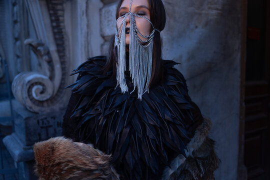 Dark glamour makeup and a silver chain veil, close-up beauty portrait in gothic style