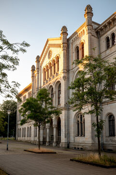 Hanover, Germany - July 1, 2026: Ornate historic stone building framed by mature trees in Hanover city centre.