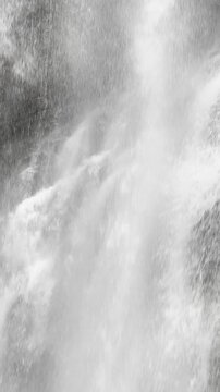 Abstract vertical motion of a powerful waterfall stream.