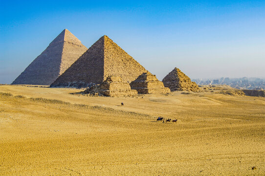 Giza pyramids standing in desert landscape with tourists