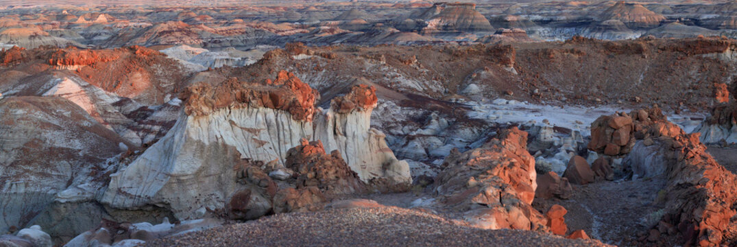 Beautiful wide panoramic view of unique badlands desert canyon rock formations at sunset