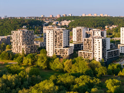 Aerial view of real modern buildings surrounded by city and nature. Residential place in the suburban area.