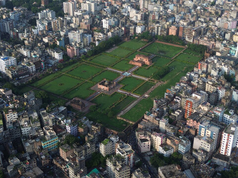 Aerial view of the historic Lalbagh Fort complex featuring lush green gardens and Mughal architecture surrounded by the dense urban cityscape of Dhaka, Dhaka Division, Bangladesh.