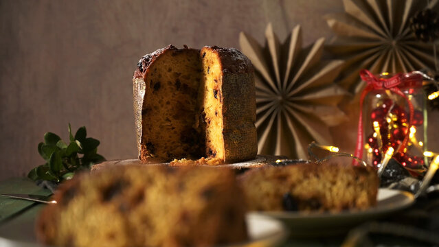 Horizontal Still Life of Sliced Panettone on Rustic Wood with Warm Background Lights