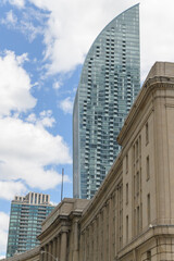 Obraz premium looking east on Front St W to historic Dominion Public Building and the tapering silhouette of Daniel Libeskind's L-Tower, a condo, at 8 The Esplanade, Toronto