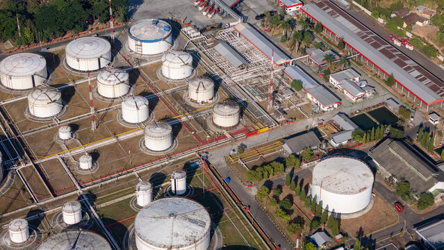 Aerial view of an industrial fuel storage facility with numerous large white cylindrical tanks, interconnected pipelines, and service buildings in Yogyakarta, Special Region of Yogyakarta, Indonesia.
