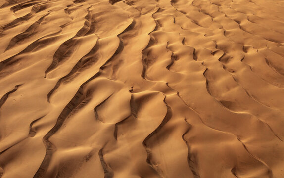 Aerial view of Katpana Desert with undulating sand dunes and intricate wind-swept patterns Skardu, Pakistan.