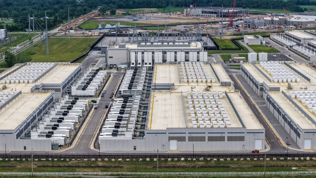 Aerial view of a large-scale data center facility featuring multiple industrial buildings, rows of cooling units, and surrounding infrastructure in Columbus, Ohio, United States.