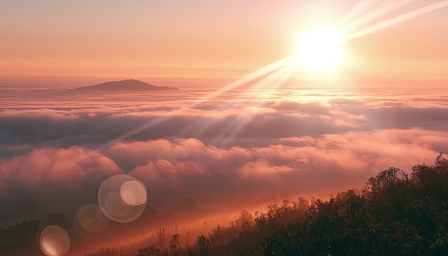 A vibrant sunset casts golden light over a vast layer of soft, rolling clouds