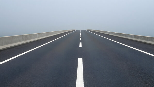 Endless Highway in Fog: A long, empty asphalt highway stretches into a thick fog, creating a sense of mystery and the unknown.