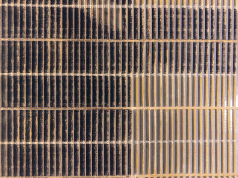Aerial view of Arlington solar farm with rows of photovoltaic panels arranged in a geometric pattern in Arlington, Oregon, United States.