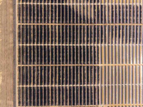 Aerial view of the Arlington solar farm featuring long rows of photovoltaic panels arranged in a grid pattern across a dry landscape Arlington, Oregon, United States.