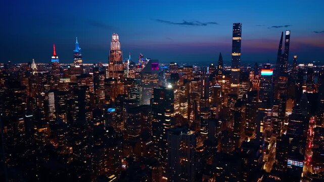Footage at the tops of skyscrapers in Manhattan. Lights of gorgeous New York City, USA at night.