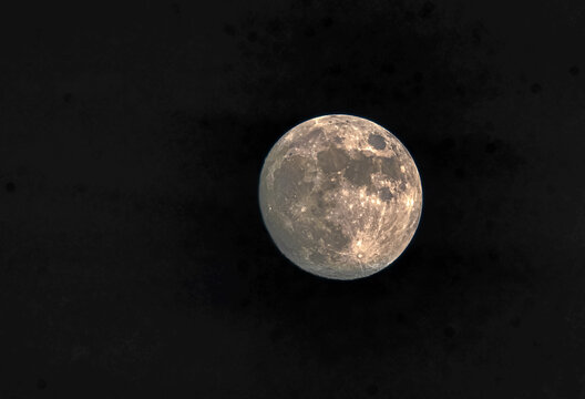 View of the full moon glowing against the dark night sky in Jahanian, Pakistan.