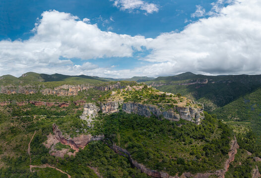 Aerial view of Siurana village perched on dramatic sandstone cliffs in Catalonia, Spain. Historic mountain settlement surrounded by rugged landscapes