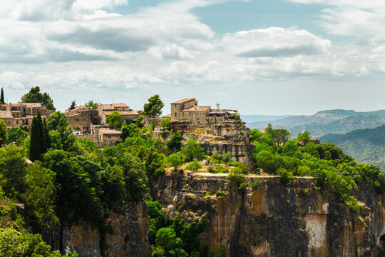 Siurana medieval village overlooking dramatic canyon cliffs and forested mountains, panoramic landscape of one of Catalonia